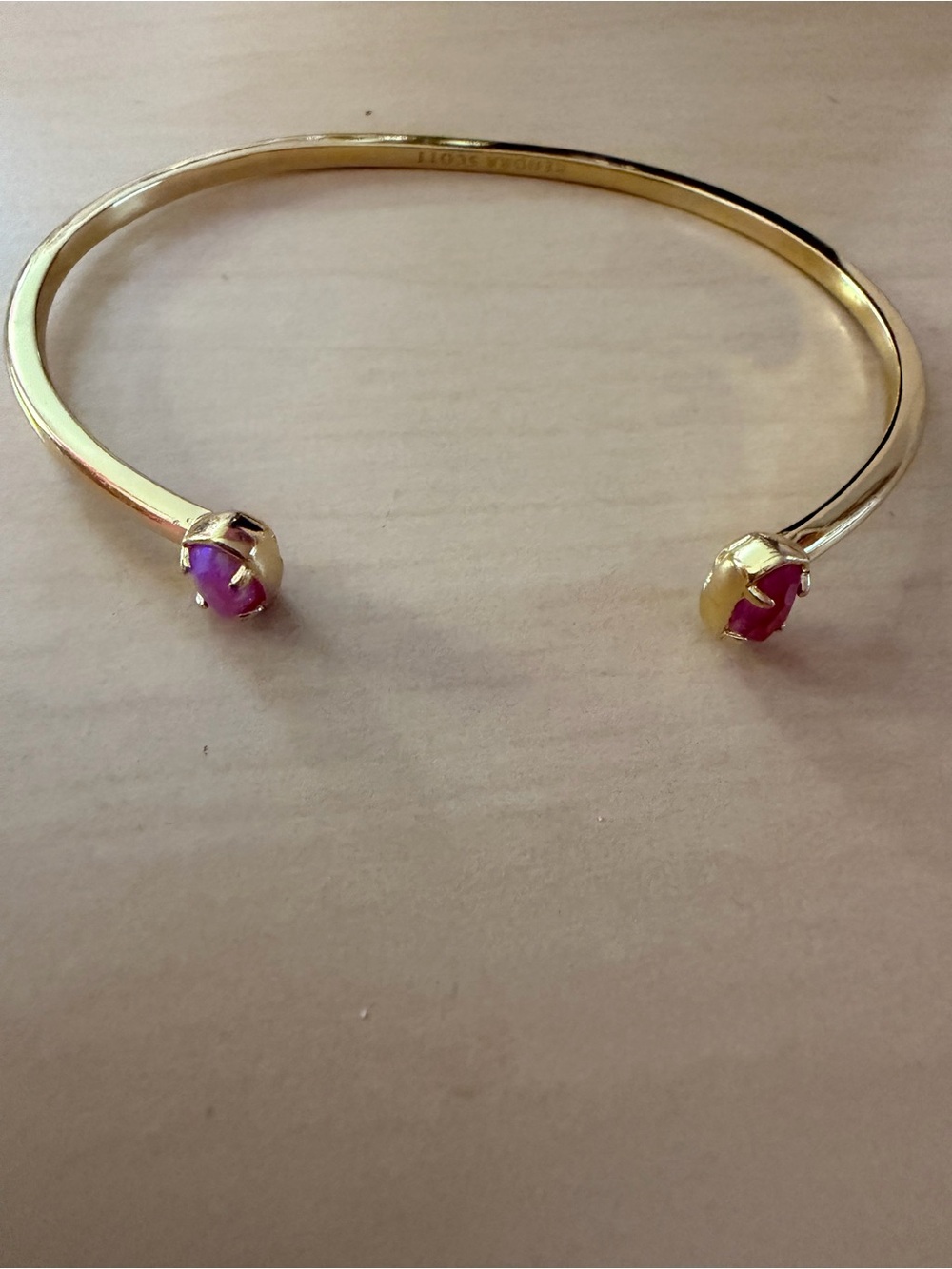 Kendra Scott gold open cuff with 2 different pink stones